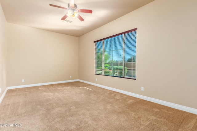 empty room featuring carpet flooring and ceiling fan