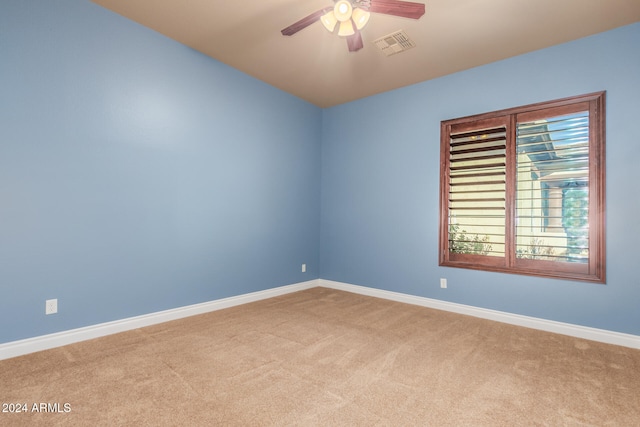 spare room with light carpet and ceiling fan