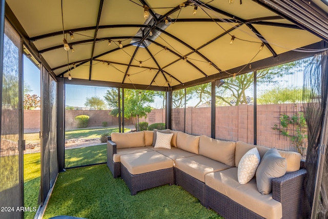 sunroom featuring ceiling fan and lofted ceiling