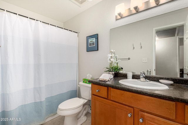 bathroom featuring vanity, tile patterned floors, and toilet