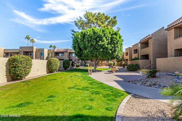 view of home's community with a yard