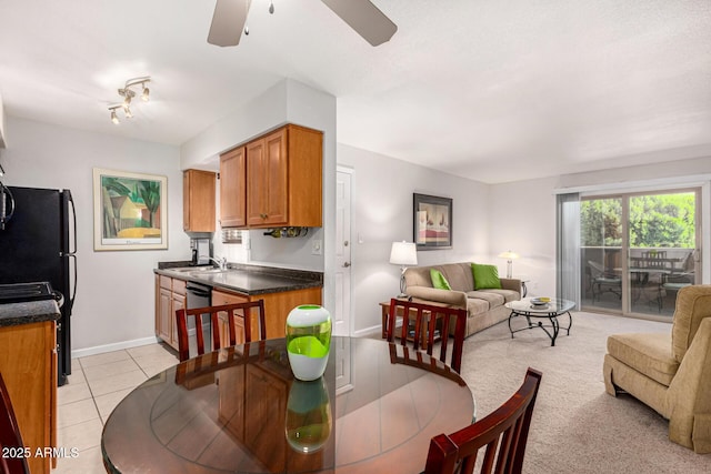 dining area with sink, light tile patterned floors, and ceiling fan