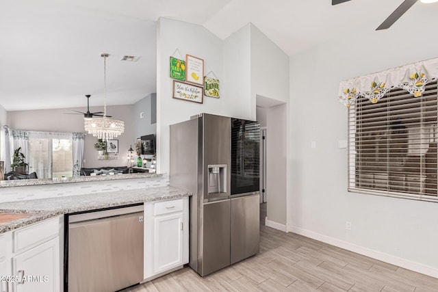 kitchen featuring appliances with stainless steel finishes, ceiling fan, white cabinetry, and decorative light fixtures