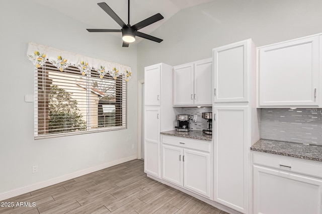 kitchen featuring white cabinetry, backsplash, and stone countertops