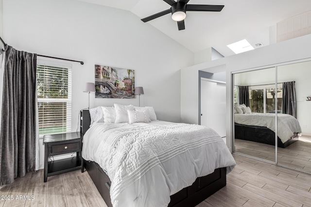 bedroom with multiple windows, a closet, high vaulted ceiling, and ceiling fan