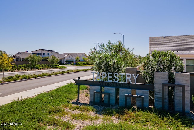 community / neighborhood sign featuring a residential view