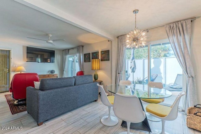 dining room featuring wood finish floors and ceiling fan with notable chandelier