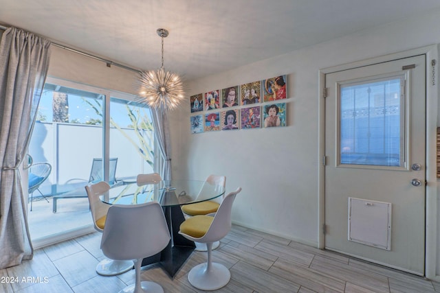 dining space featuring a notable chandelier and baseboards
