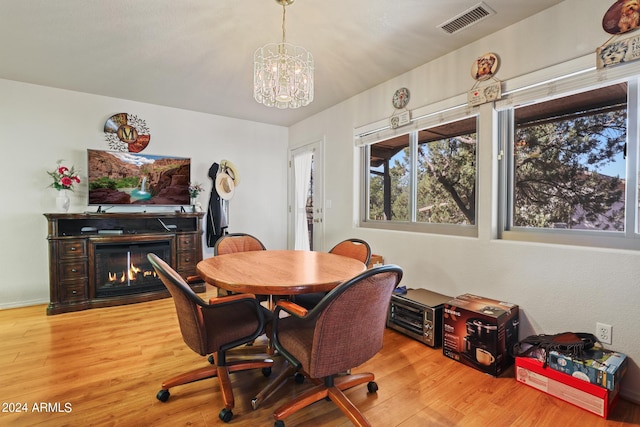 dining room featuring light hardwood / wood-style floors and a notable chandelier