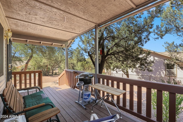 wooden terrace featuring area for grilling