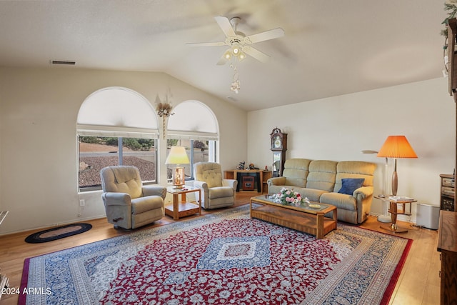 living room featuring ceiling fan, vaulted ceiling, and hardwood / wood-style floors