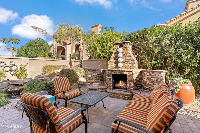 view of patio featuring an outdoor living space with a fireplace