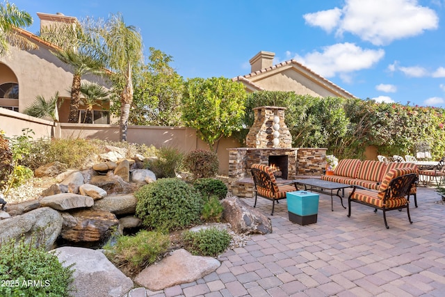 view of patio / terrace with an outdoor living space with a fireplace