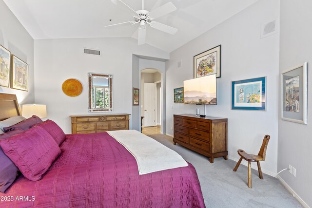 bedroom featuring ceiling fan, light colored carpet, and vaulted ceiling