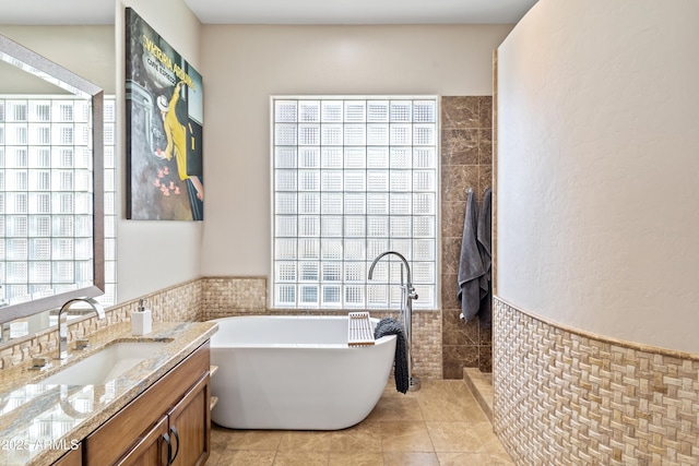 bathroom featuring tile patterned floors, vanity, separate shower and tub, and tile walls