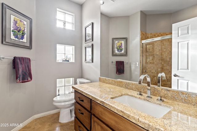 bathroom with tile patterned floors, vanity, toilet, and a shower with shower door