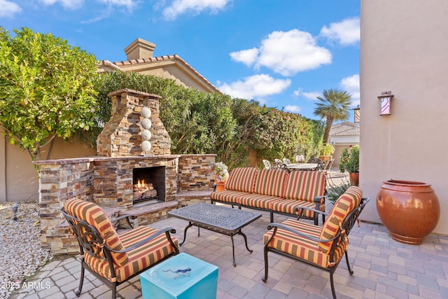 view of patio featuring an outdoor living space with a fireplace