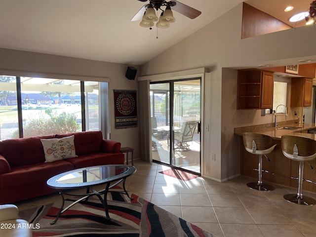 living room with ceiling fan, light tile patterned floors, sink, and high vaulted ceiling