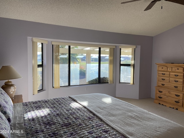 unfurnished bedroom with carpet, ceiling fan, and a textured ceiling