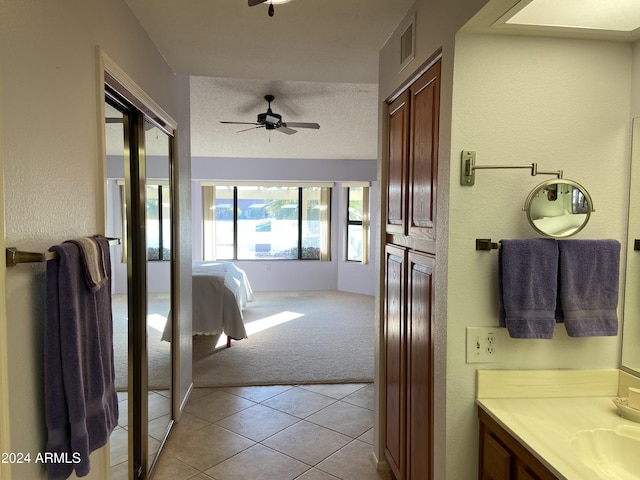 bathroom featuring tile patterned floors, ceiling fan, a textured ceiling, and vanity