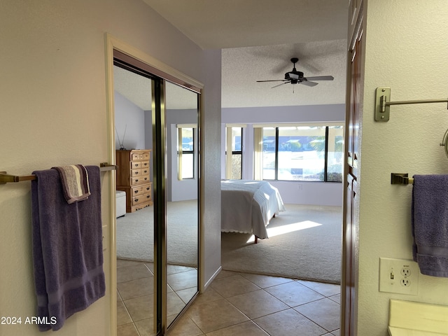 hallway featuring light carpet and a textured ceiling