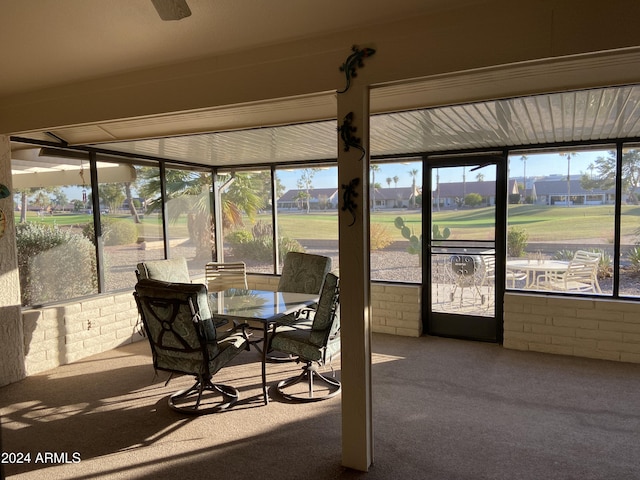 sunroom / solarium with ceiling fan and a healthy amount of sunlight