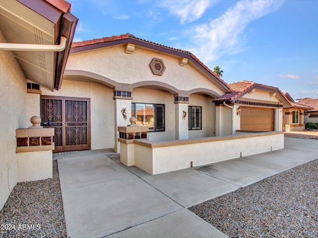 mediterranean / spanish-style house with a garage