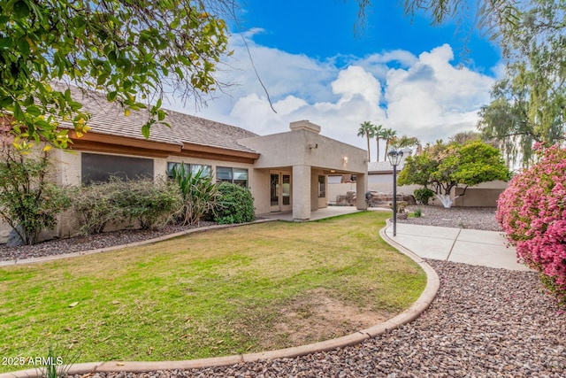 exterior space with a patio area and a lawn