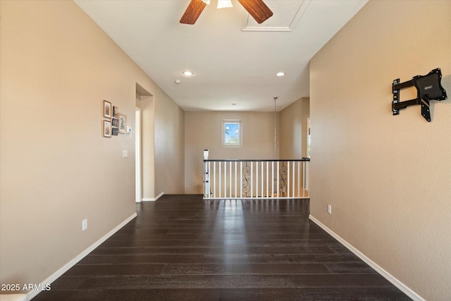 hallway with recessed lighting, an upstairs landing, wood finished floors, and baseboards