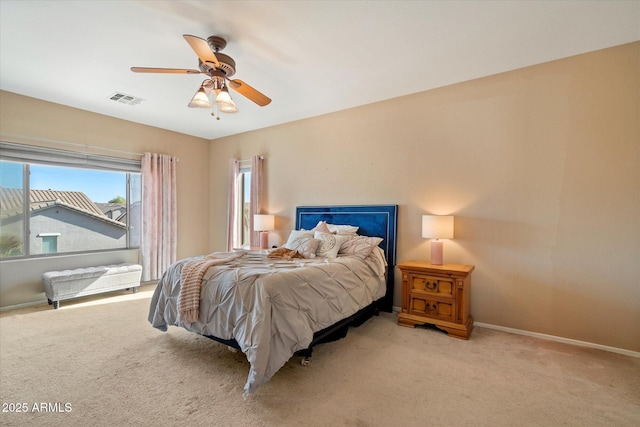 carpeted bedroom with baseboards, a ceiling fan, and visible vents