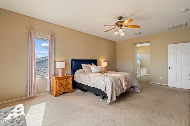 bedroom with carpet flooring, baseboards, visible vents, and connected bathroom