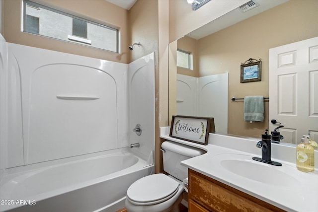 bathroom featuring toilet, washtub / shower combination, visible vents, and a wealth of natural light