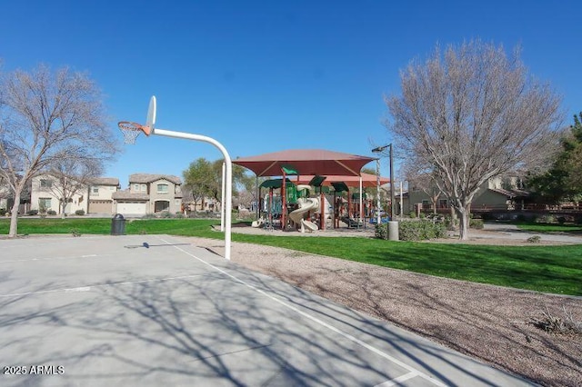 community jungle gym featuring a yard and community basketball court