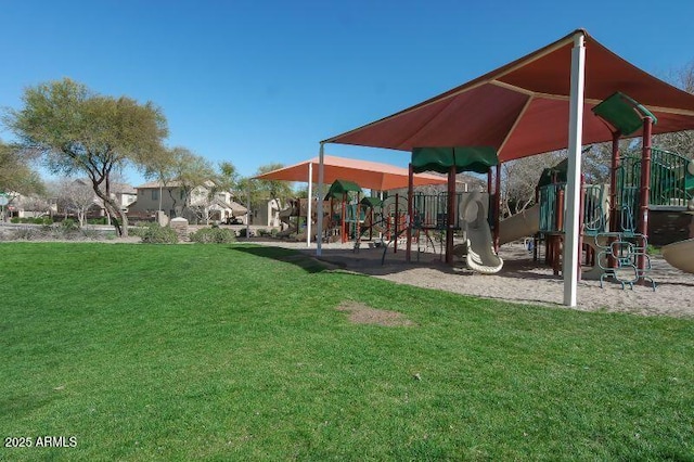 view of home's community featuring a yard and playground community