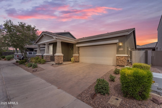 9853 E Solstice Ave, Mesa, AZ 85212 - view of front of home with stone siding, decorative driveway, an attached garage, and stucco siding