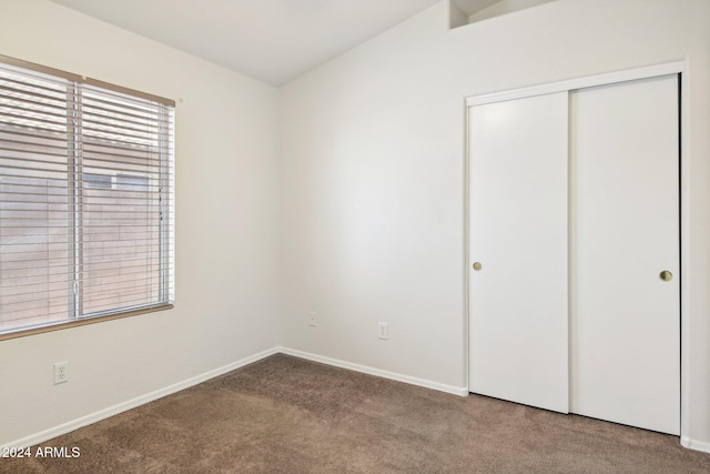 unfurnished bedroom with carpet and a closet