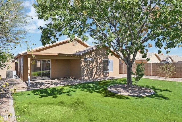 rear view of house with a yard, a patio, and central air condition unit