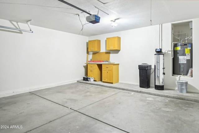 garage with a garage door opener and electric water heater