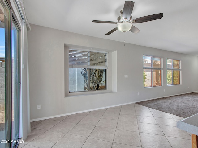 unfurnished room featuring light tile patterned flooring and ceiling fan