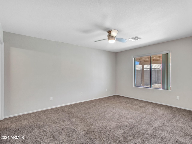 spare room with carpet and ceiling fan