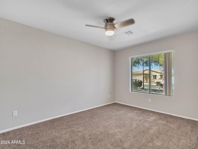 spare room with carpet floors and ceiling fan