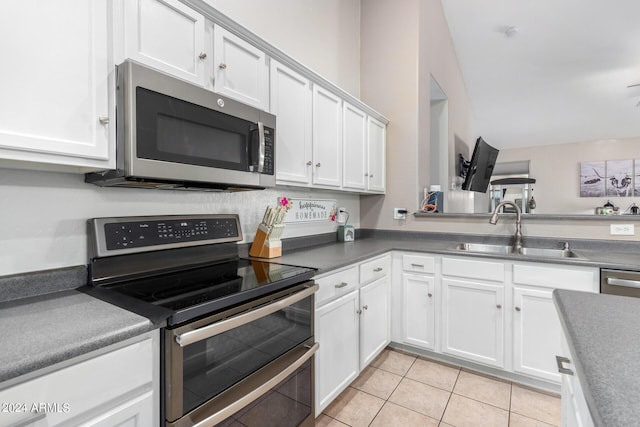 kitchen featuring sink, white cabinets, and appliances with stainless steel finishes