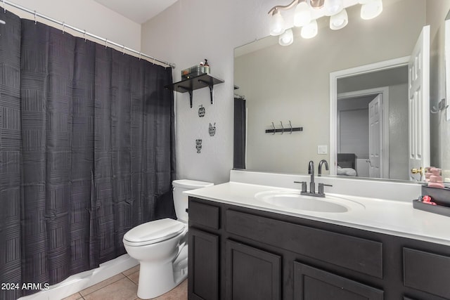 bathroom featuring toilet, vanity, and tile patterned flooring