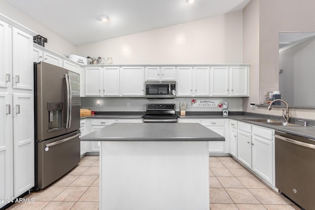 kitchen featuring lofted ceiling, light tile patterned floors, sink, and stainless steel appliances