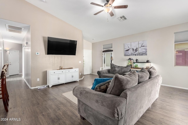 living room featuring ceiling fan, dark hardwood / wood-style flooring, and vaulted ceiling