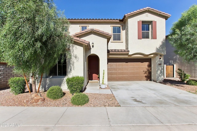 6641 N Desert Shadow Ln, Phoenix, AZ 85014 - view of front facade with a tiled roof, an attached garage, stucco siding, driveway, and fence