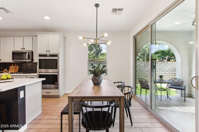 6641 N Desert Shadow Ln, Phoenix, AZ 85014 - dining space featuring a chandelier and recessed lighting