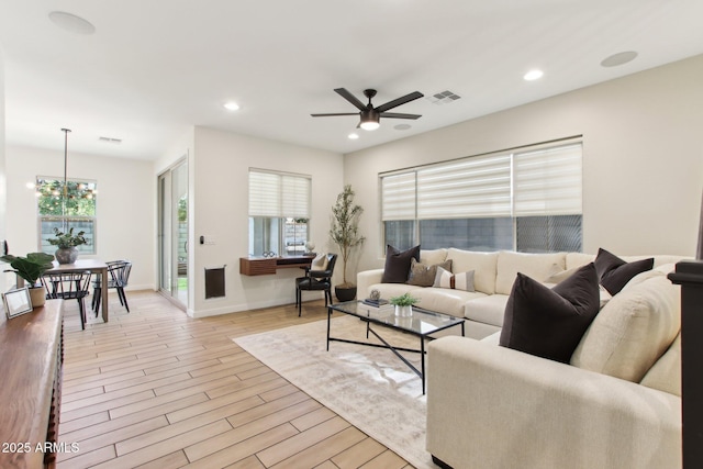 6641 N Desert Shadow Ln, Phoenix, AZ 85014 - living room featuring ceiling fan, healthy amount of natural light, a chandelier, light wood finished floors, and recessed lighting