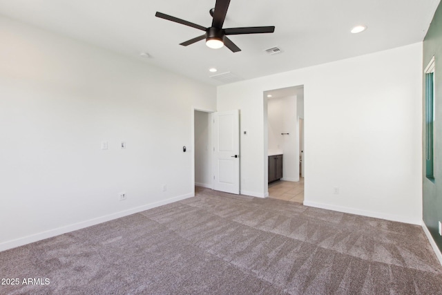 6641 N Desert Shadow Ln, Phoenix, AZ 85014 - unfurnished bedroom with light colored carpet, recessed lighting, baseboards, and ensuite bath