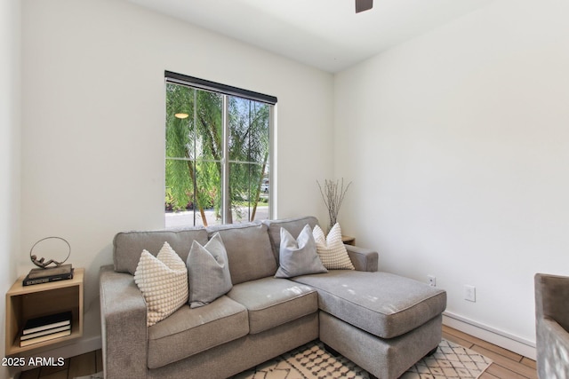 6641 N Desert Shadow Ln, Phoenix, AZ 85014 - living area with ceiling fan, light wood finished floors, and baseboards